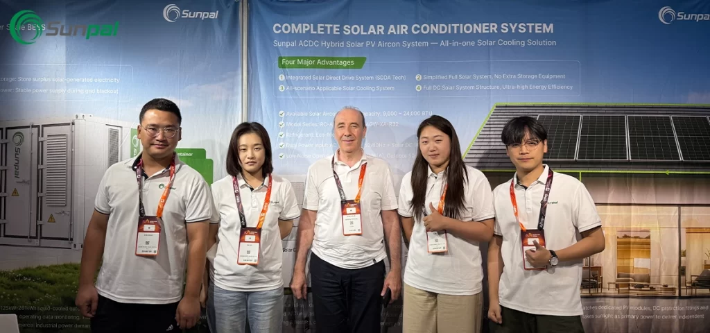 The Sunpal team standing in front of their exhibition booth featuring the ACDC hybrid solar air conditioner system at Middle East Energy 2026.